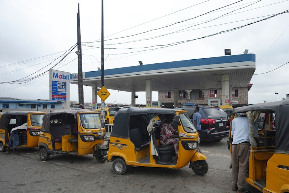 Tuktuk drivers queue to buy fuel at a petrol station in Lagos, Nigeria, Wednesday, July. 31, 2024 (AP)