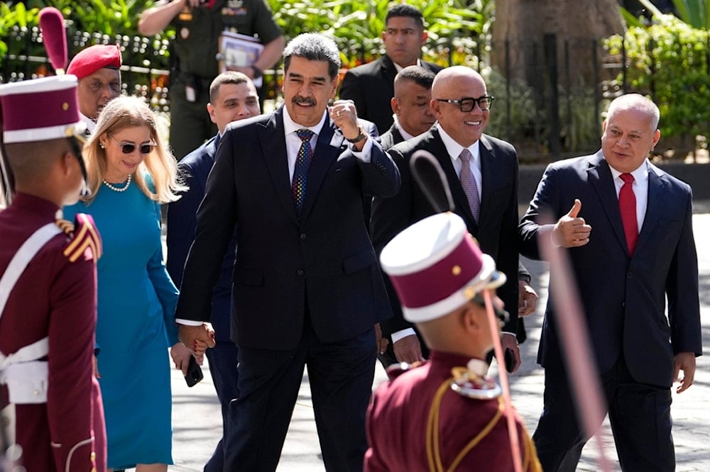 Venezuelan President Nicolas Maduro gestures to supporters as he walks hand-in-hand with his wife Cilia Flores upon arrival at the National Assembly for his swearing-in ceremony for a third term in Caracas, Venezuela, Friday, Jan. 10, 2025 (AP)