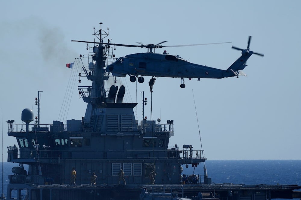 A military helicopter loads marines over a naval ship during an annual NATO naval exercise on Turkey's western coast on the Mediterranean, on September 15, 2022. (AP)