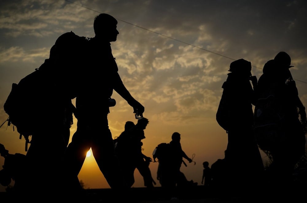 A silhouette of migrants walking at sunset, undated. (AFP)