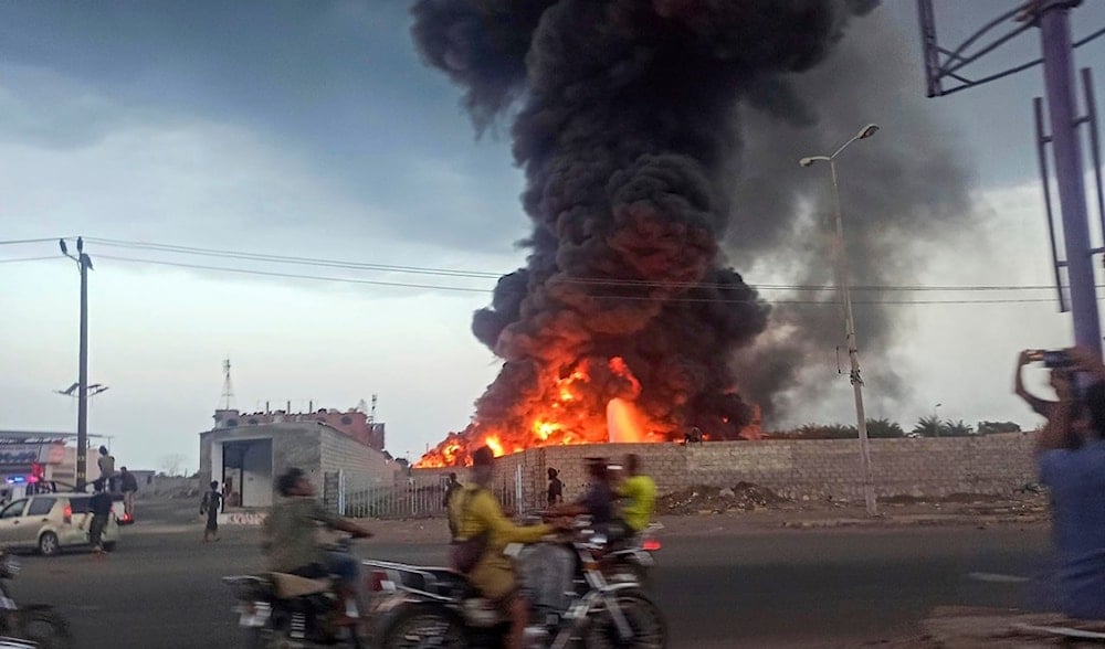 A large fire and plume of smoke is visible in the port city of Hodeidah, Yemen, on Sunday, Sept. 29, 2024, after Israeli strikes on the city. (AP)