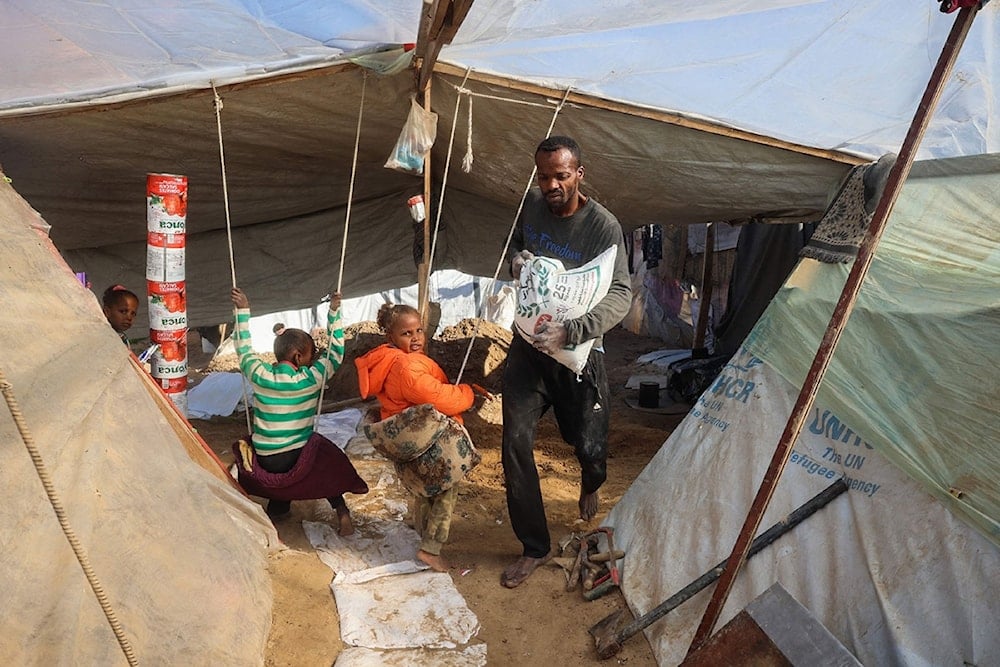 Palestinian father Tayseer Obeid who was displaced with his family from the North of the besieged Gaza Strip