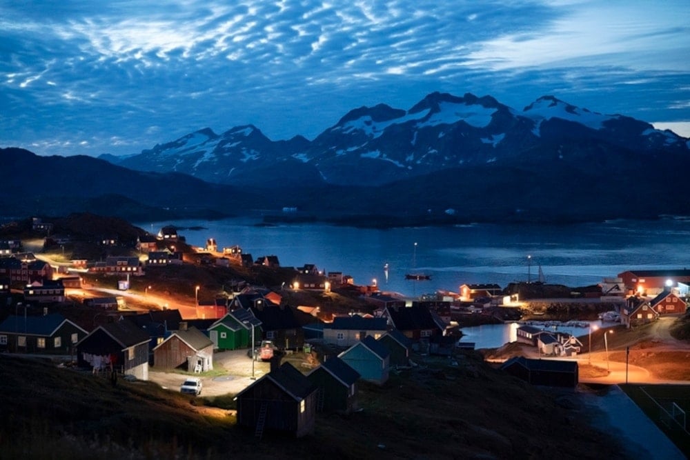 Homes are illuminated after the sunset in Tasiilaq, Greenland, and Friday, August 16, 2019. (AP)