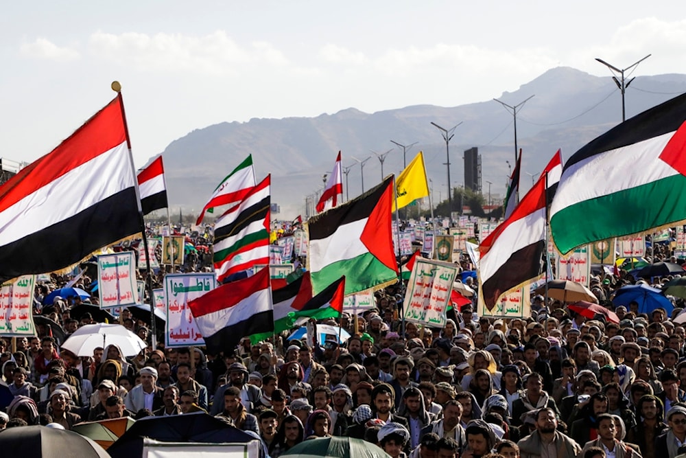 Yemenis wave Palestinian and Yemeni flags during a rally in Sanaa, Yemen, Friday, Jan. 10, 2025 (AP Photo/Osamah Abdulrahman)