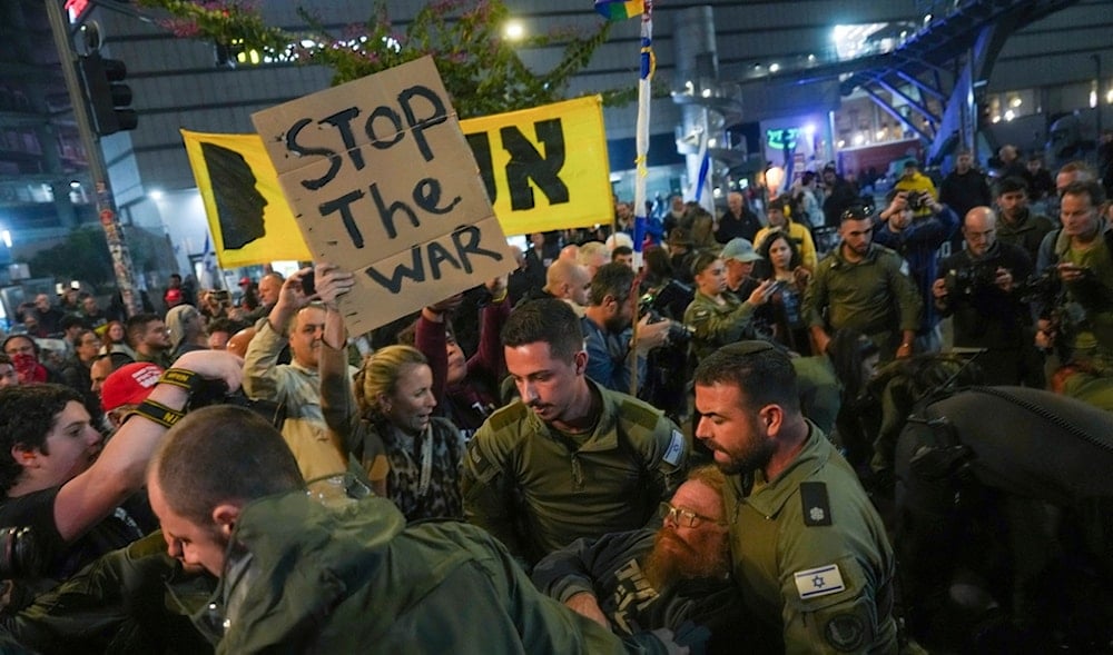 Police scuffle with demonstrators who block a road during a protest demanding a cease-fire deal and the immediate release of captives held in the Gaza Strips, in Tel Aviv, 