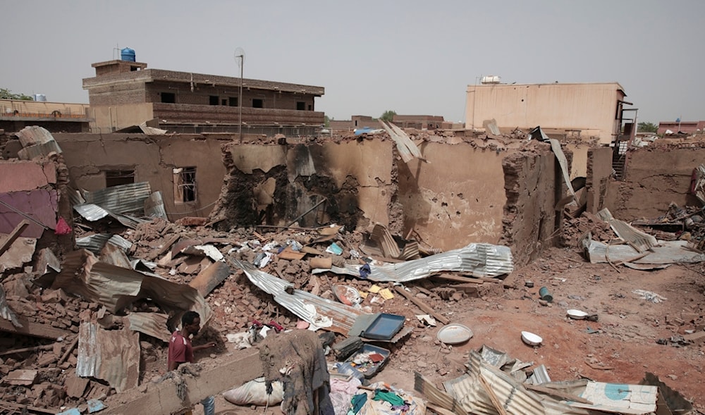  A man walks by a house hit in recent fighting in Khartoum, Sudan, April 25, 2023. (AP)