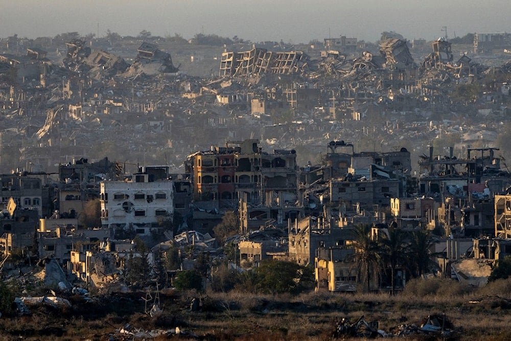 Destroyed buildings stand inside the Gaza Strip, as seen from the separation line with Gaza, Tuesday, Jan. 7, 2025. (AP Photo/Ariel Schalit)