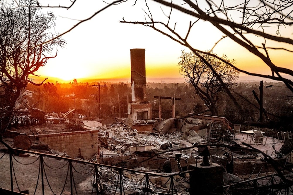 The sun rises behind a home destroyed by the Palisades Fire in the Pacific Palisades community of Los Angeles on Sunday, Jan. 12, 2025, (AP Photo/Noah Berger)