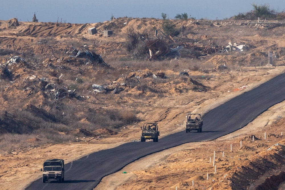 Israeli military vehicles move inside the Gaza Strip, as seen from southern 