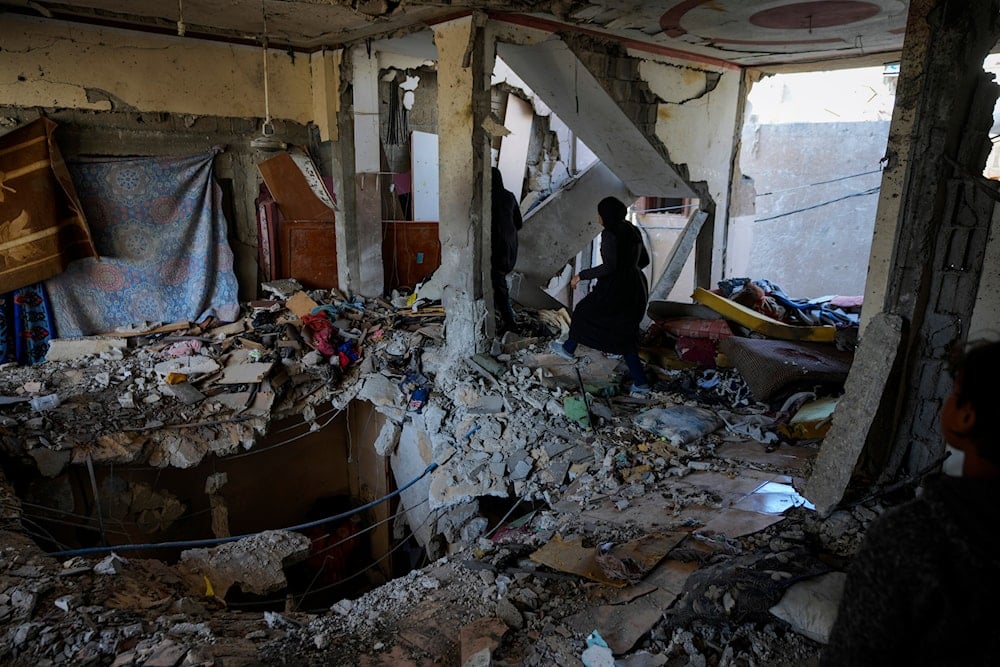 Palestinian women look at a damaged residential building following an overnight Israeli strike in Deir al-Balah, Gaza Strip, on January 9, 2025. (AP)