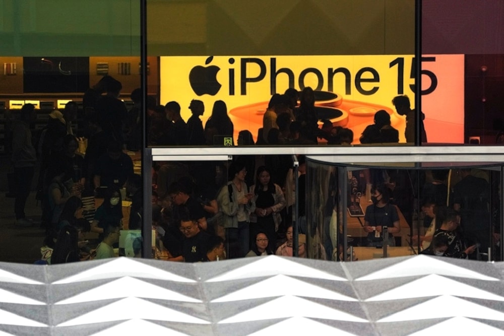 People visit an Apple Store to try out the latest iPhone 15 handsets, which have started its sale this week, at an outdoor shopping mall in Beijing, Sunday, Sept. 24, 2023 (AP)