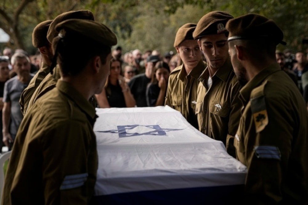 Israeli soldiers carry the flagged-covered coffin of a sergeant killed near Ramot Naftali, occupied Palestine, Monday October 14, 2024. (AP)