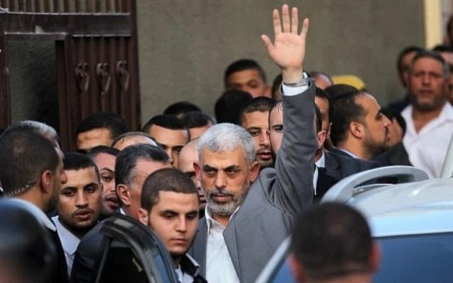 The leader of the Hamas terror group in the Gaza Strip, Yahya Sinwar, waves as he arrives for a meeting with the Palestinian Authority's prime minister and other officials in Gaza City on October 2, 2017. (AFP)