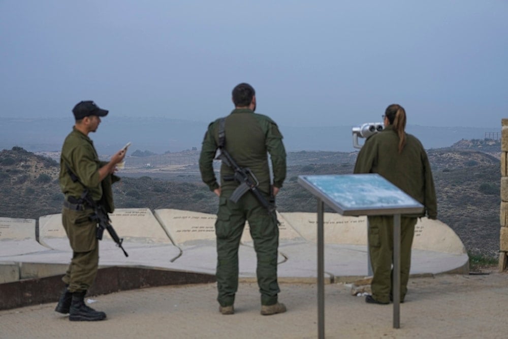 Israeli soldiers stand in an observation point overlooking the Gaza Strip from southern Palestine, Thursday, Jan. 16, 2025. (AP Photo/Tsafrir Abayov)