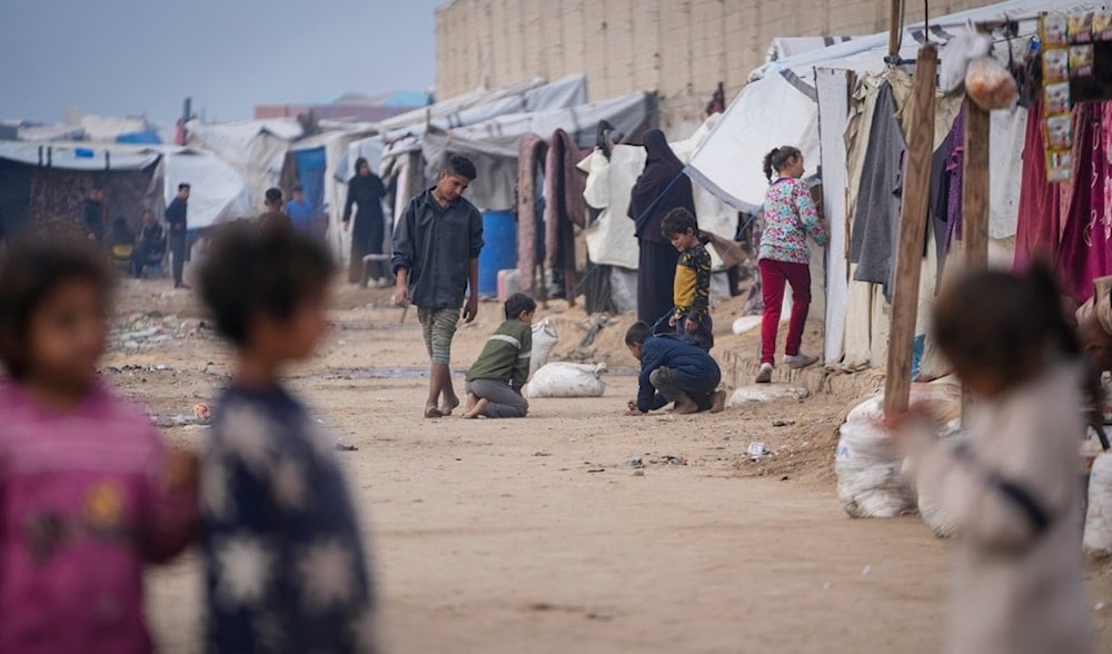 Palestinian children play at a tent camp for displaced Palestinians in Deir al-Balah, central Gaza Strip, Thursday Jan. 16, 2025. (AP)