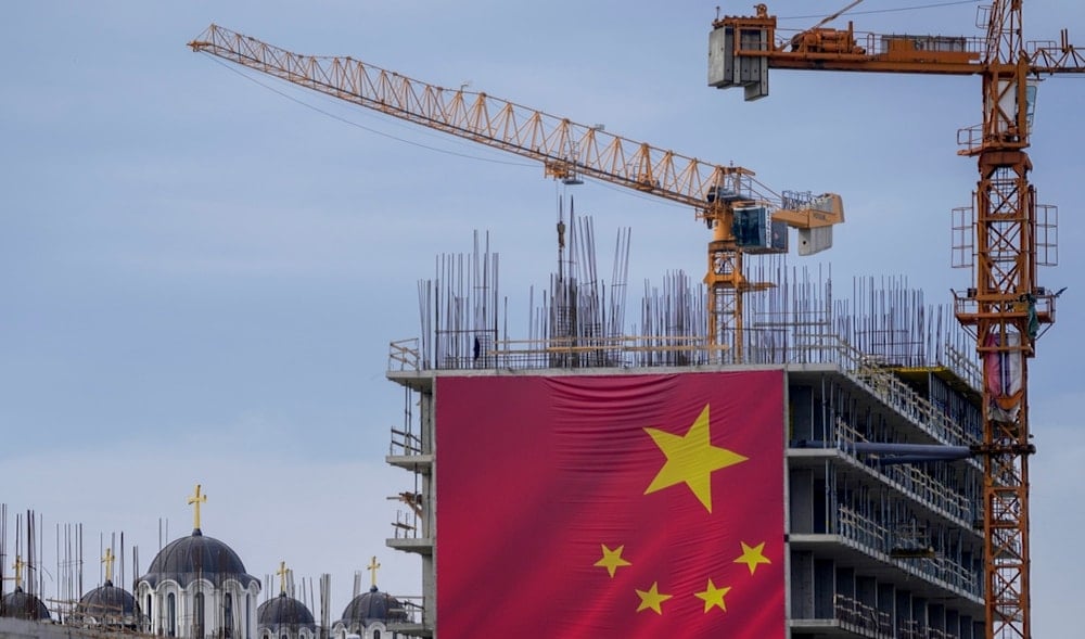 A giant Chinese national flag is seen on a building in front of a church during a welcome ceremony for Chinese President Xi Jinping at the Serbia Palace in Belgrade, Serbia, Wednesday, May 8, 2024. (AP)