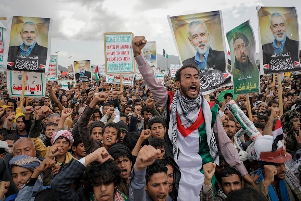 Yemenis hold posters showing former Hamas leader Ismail Haniyeh during an anti-Israeli and anti-American rally in Sanaa, Yemen, Friday, August 16, 2024 (AP)