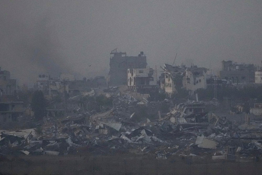 Destroyed buildings by Israeli bombardments as seen inside the Gaza Strip from southern Israel, Thursday, Jan. 16, 2025. (AP Photo/Ariel Schalit)