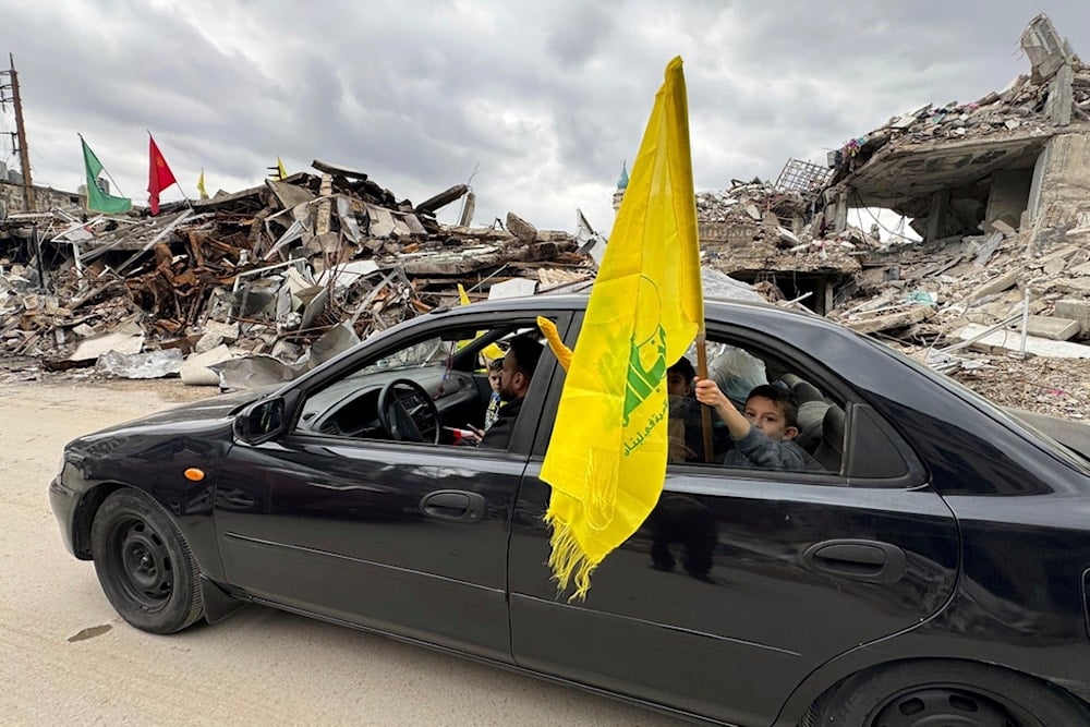 A boy holds a Hezbollah flag following a ceasefire between the Israeli occupation and Hezbollah on Nov. 28, 2024, in Nabatiyeh, southern Lebanon (AP)