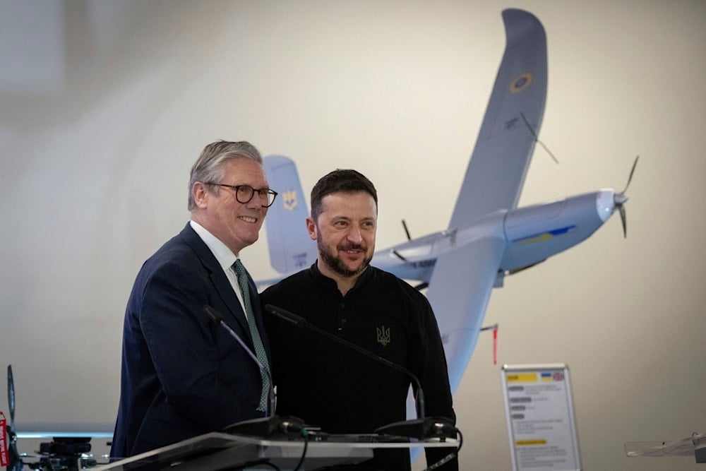 British Prime Minister Keir Starmer and Ukrainian President Volodymyr Zelensky smile as they stand in front of a drone built in Ukraine with funding from Britain, in Kiev, Ukraine Thursday, Jan. 16, 2025 (AP)