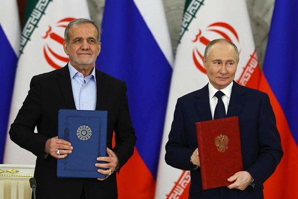 Russian President Vladimir Putin, right, and Iranian President Masoud Pezeshkian attend a signing ceremony at the Kremlin in Moscow, Russia, Friday, Jan. 17, 2025. (AP)