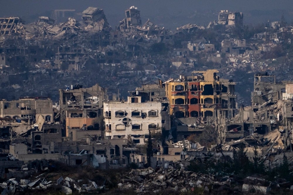 Destroyed buildings by Israeli bombardments as seen inside the Gaza Strip from southern occupied Palestine, Thursday, Jan. 16, 2025. (AP Photo/Ariel Schalit)