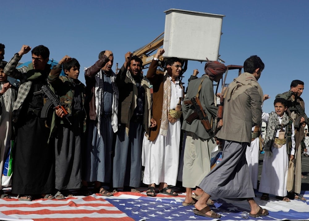 Yemenis step on an American flag during an anti-US and Israeli occupation rally in Sanaa, Yemen, Friday, Jan. 17, 2025 (AP)