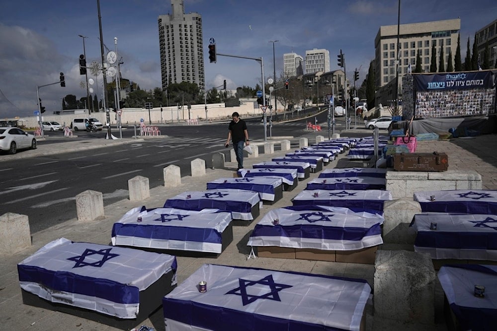 Symbolic coffins are displayed in al-Quds to protest a prisoner swap deal as the Israeli security cabinet is set to decide whether to approve a deal that would release dozens of captives held in Gaza and pause the war, Friday, Jan. 17, 2025 (AP)