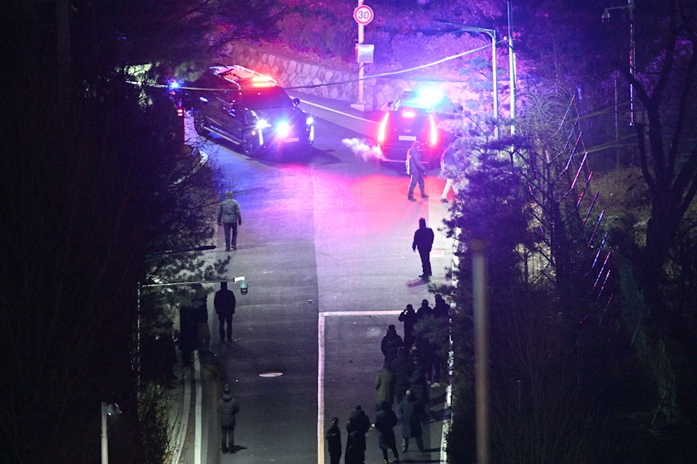 Presidential security service vehicles within the compound of the presidential residence as seen from a hill early on Jan. 15. (AFP via Getty Images