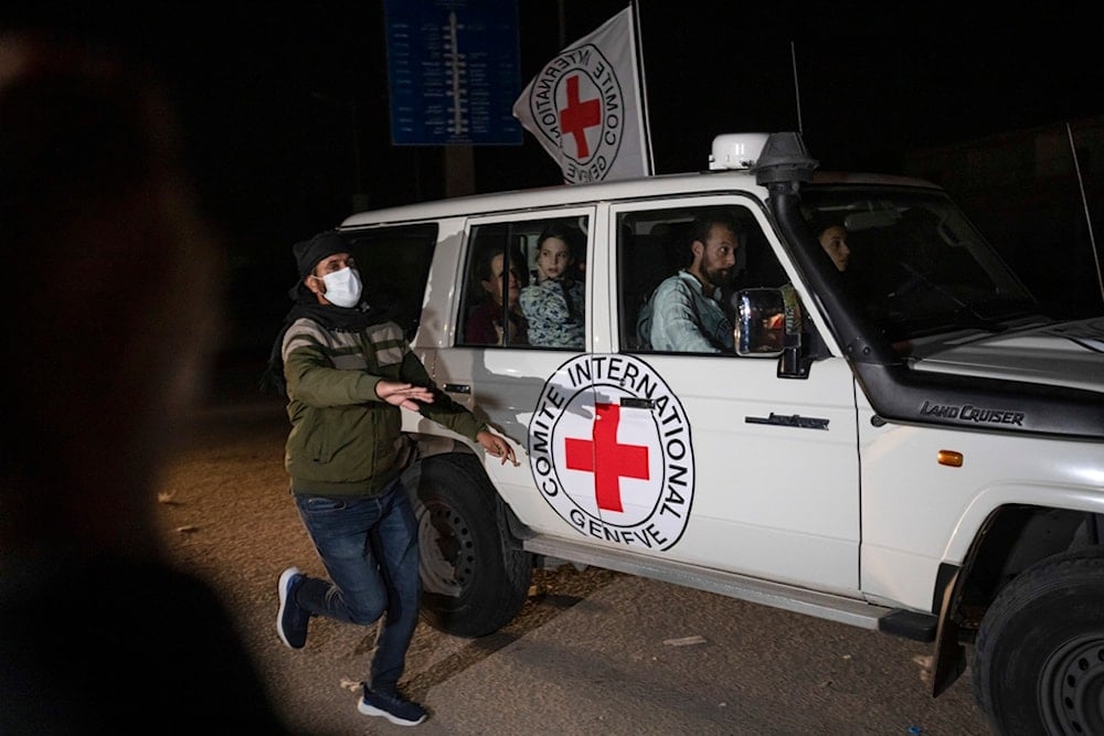 A Red Cross vehicle carrying Israeli captives drives by at the Gaza Strip crossing into Egypt in Rafah on Nov. 25, 2023 (AP)