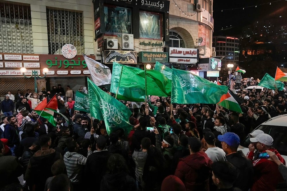 Palestinians wave Hamas flags as they celebrate the release of Palestinian prisoners in Nablus in the West Bank, Nov. 24, 2023. (AP)