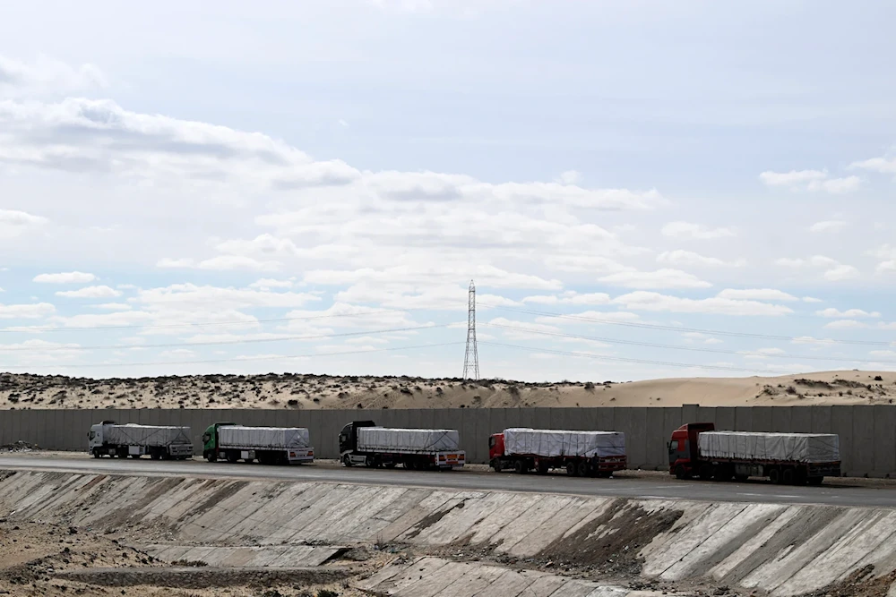 Trucks carrying aid for Gaza line up waiting near a checkpoint along a road in Egypt's northern Sinai peninsula near the city of Bir al-Abd on January 19, 2025 (AFP)