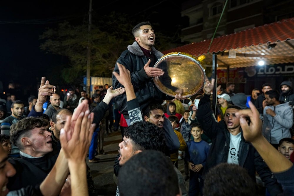 Palestinians celebrate the announcement of a ceasefire deal between Hamas and Israel in Deir al-Balah, central Gaza Strip, on January 15, 2025. (AP)