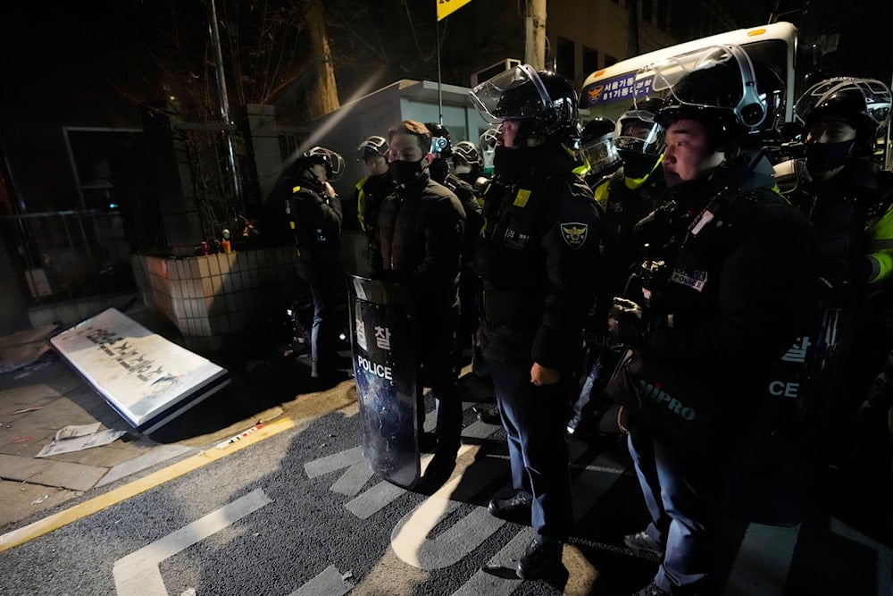 Police officers stand outside of the Seoul Western District Court after supporters of impeached South Korean President Yoon Suk Yeol broke into the court in Seoul, South Korea, Sunday, Jan. 19, 2025. (AP)