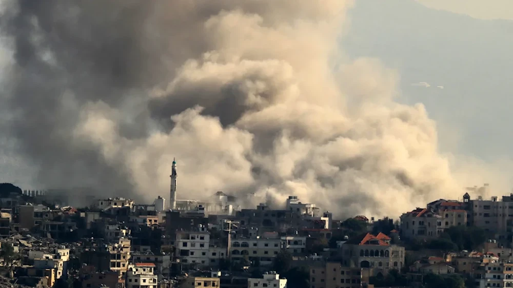 Smoke rises as Israeli occupation forces demolish residential homes in Khiam, southern Lebanon on 1 December 2024 (AFP)