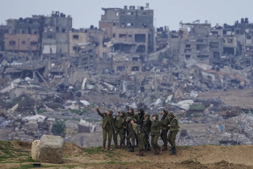 Israeli female soldiers pose for a photo on a position on the occupied Gaza Strip border Monday, Feb. 19, 2024. (AP)