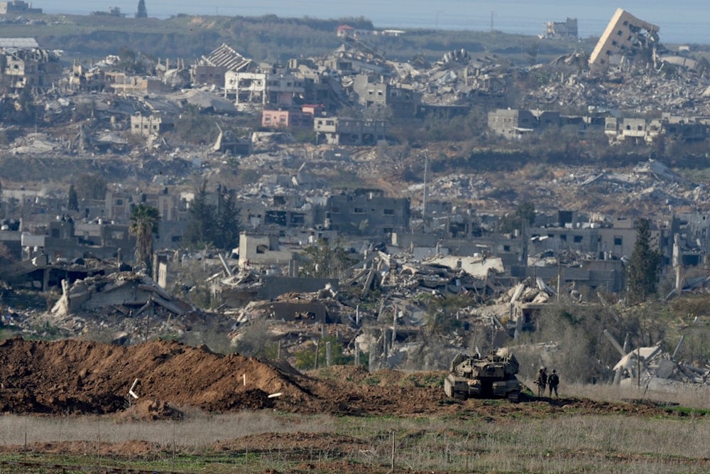 Israeli soldiers stand near a tank inside southern Gaza along the border with Israel, Sunday, Jan. 19, 2025