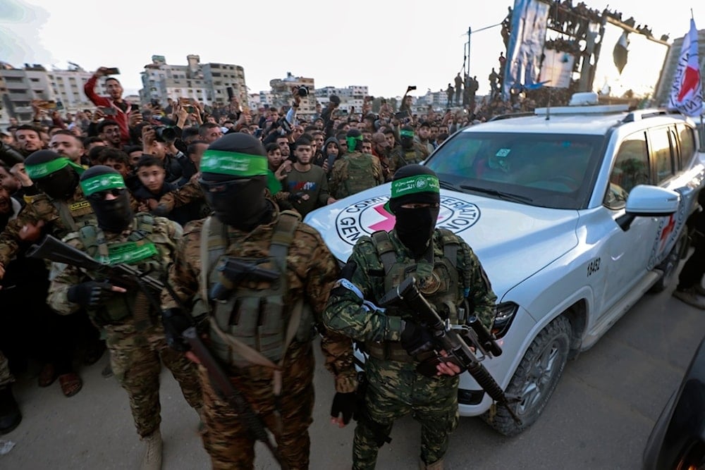 Hamas fighters escort a Red Cross vehicle to collect Israeli hostages released after a ceasefire agreement between Israel and Hamas took effect, in Gaza City Sunday, Jan. 19, 2025. (AP)