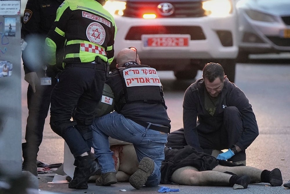 The body of a man who carried out a stabbing operation is examined by Israeli police after he was shot during the incident in Tel Aviv, occupied Palestine, Saturday, Jan. 18, 2025 (AP)