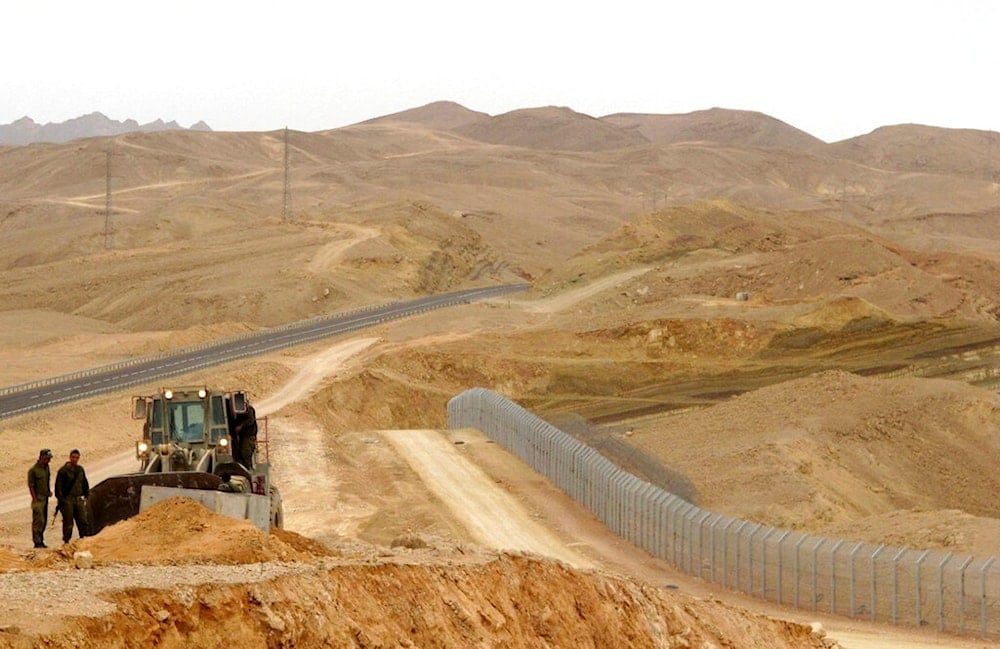 In this Feb. 15, 2012 photo, an Israeli bulldozer works at the site where 