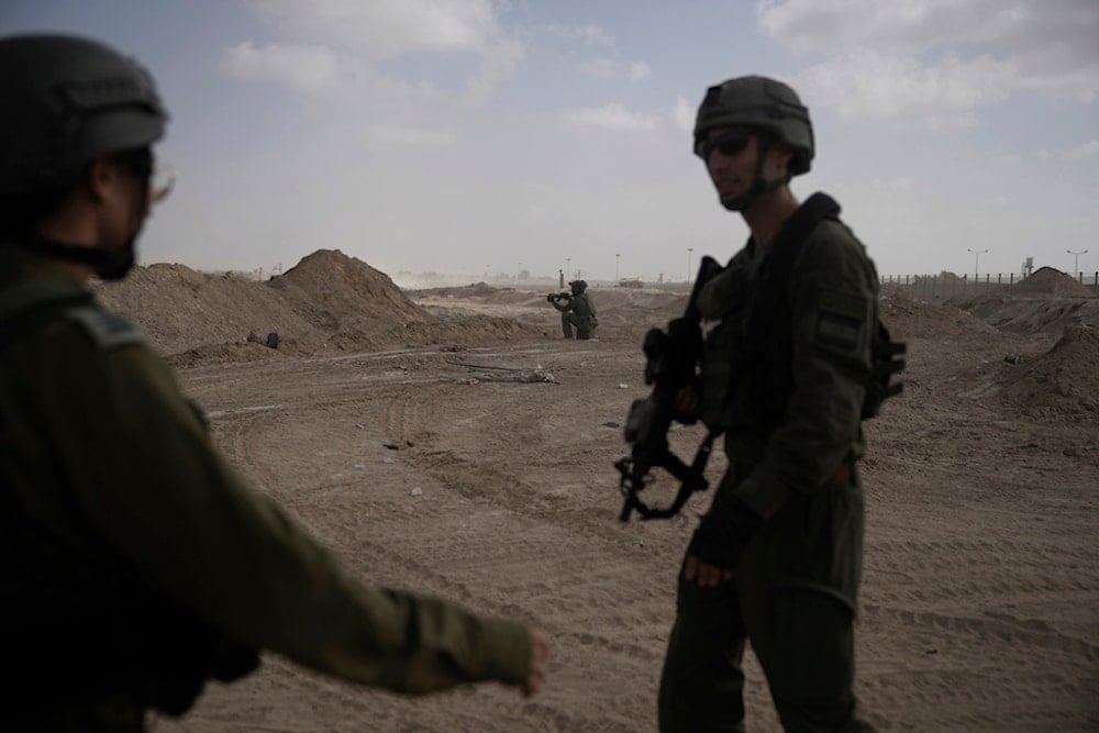 FILE - Israeli soldiers take up positions next to the Philadelphi Corridor along the border with Egypt, in the Gaza Strip, Sept. 13, 2024. (AP Photo/Leo Correa, File)