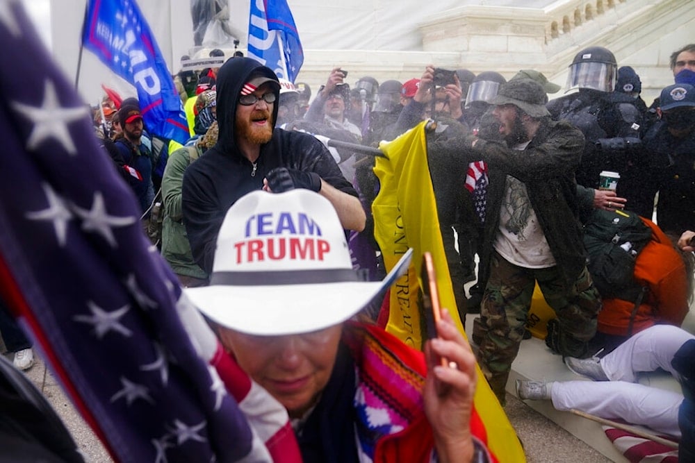 In this Jan. 6, 2021, file photo, insurrections loyal to President Donald Trump try to break through a police barrier at the Capitol in Washington, DC (AP)