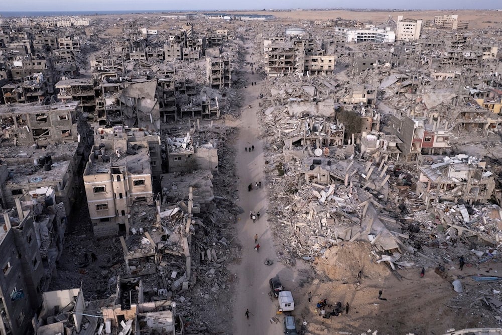 An aerial photograph taken by a drone shows Palestinians walking through the destruction caused by the Israeli air and ground offensive, in Rafah, Gaza Strip, on January 21, 2025. (AP)