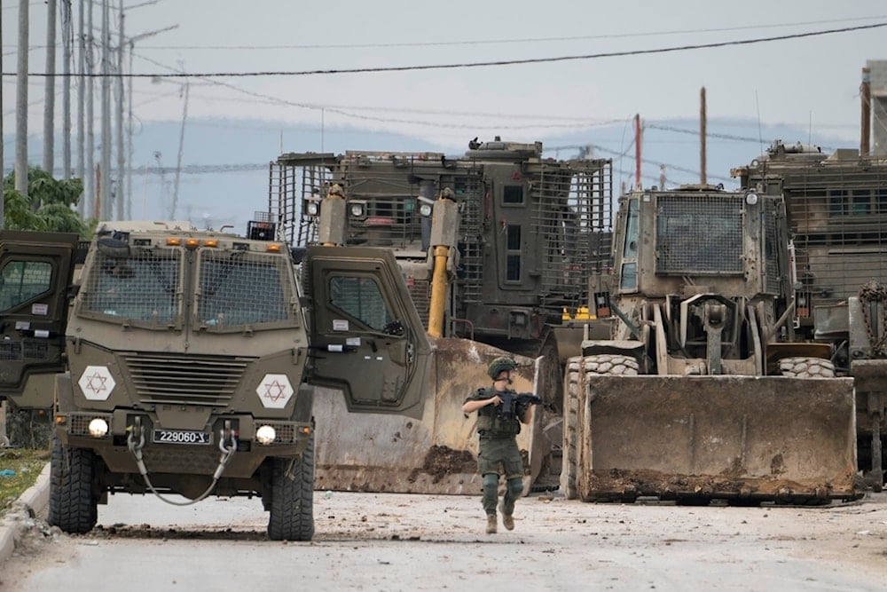 Israeli occupation forces vehicles are seen during a military operation in the West Bank city of Jenin, Wednesday, Jan. 22, 2025 (AP)