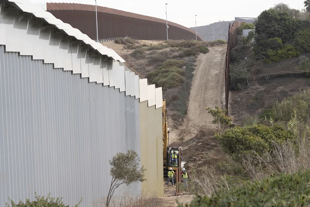 Construction crews replace sections of one of two border walls separating Mexico from the United States, Wednesday, January 22, 2025, in Mexico. (AP)