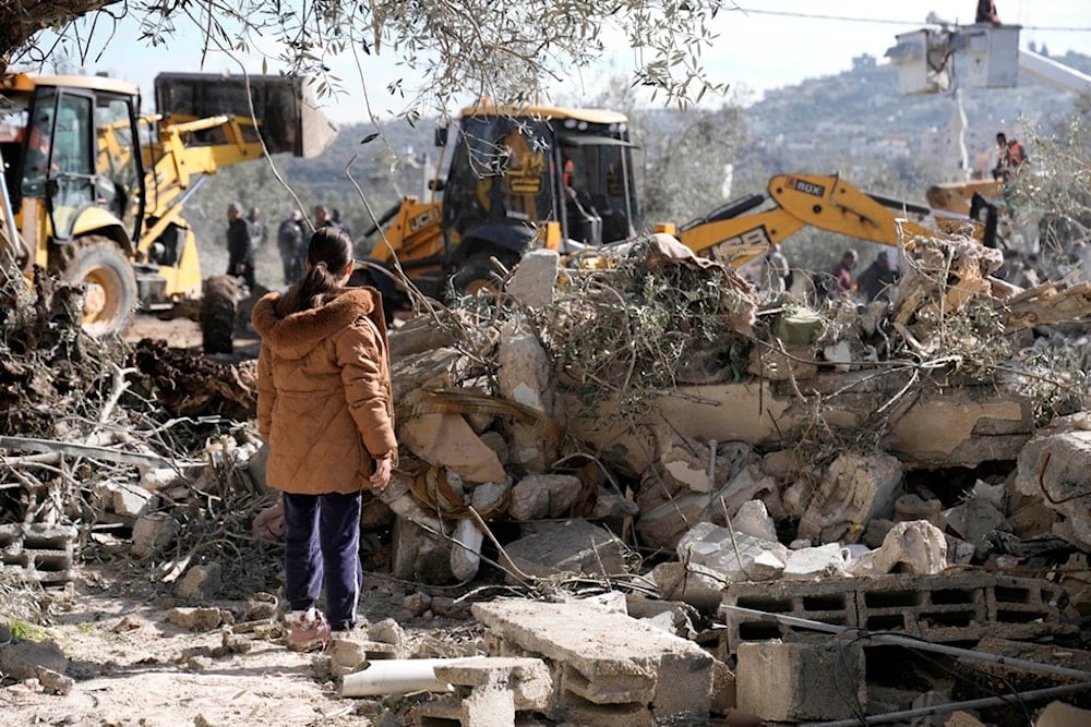 Heavy equipment clears rubble at the site of Israeli aggression in the West Bank village of Burqin, Thursday, Jan. 23, 2025 (AP)