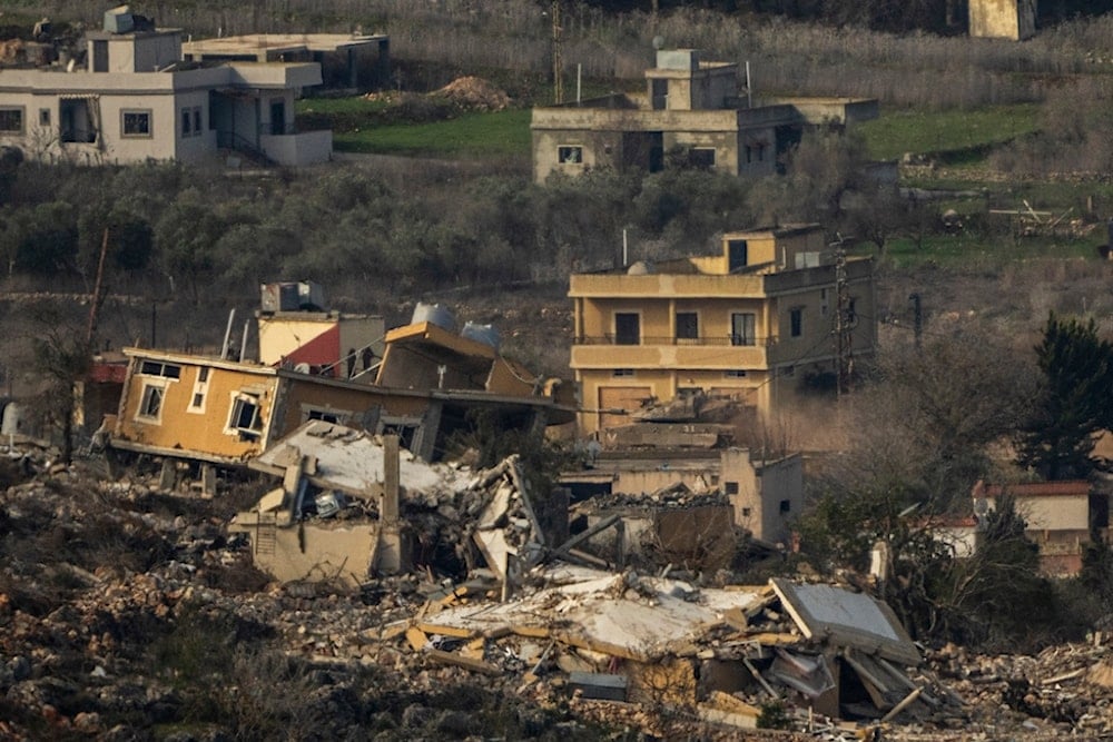 An Israeli tank maneuvers inside a village in southern Lebanon, as seen from northern Palestine, Thursday, Jan. 23, 2025. (AP Photo/Ariel Schalit)