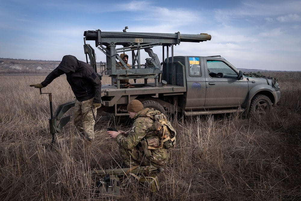 Ukrainian soldiers from The 56th Separate Motorized Infantry Mariupol Brigade prepare to fire a multiple launch rocket system based on a pickup truck towards Russian positions at the front line, near Bakhmut, Donetsk region, Ukraine, on March 5, 2024. (AP)