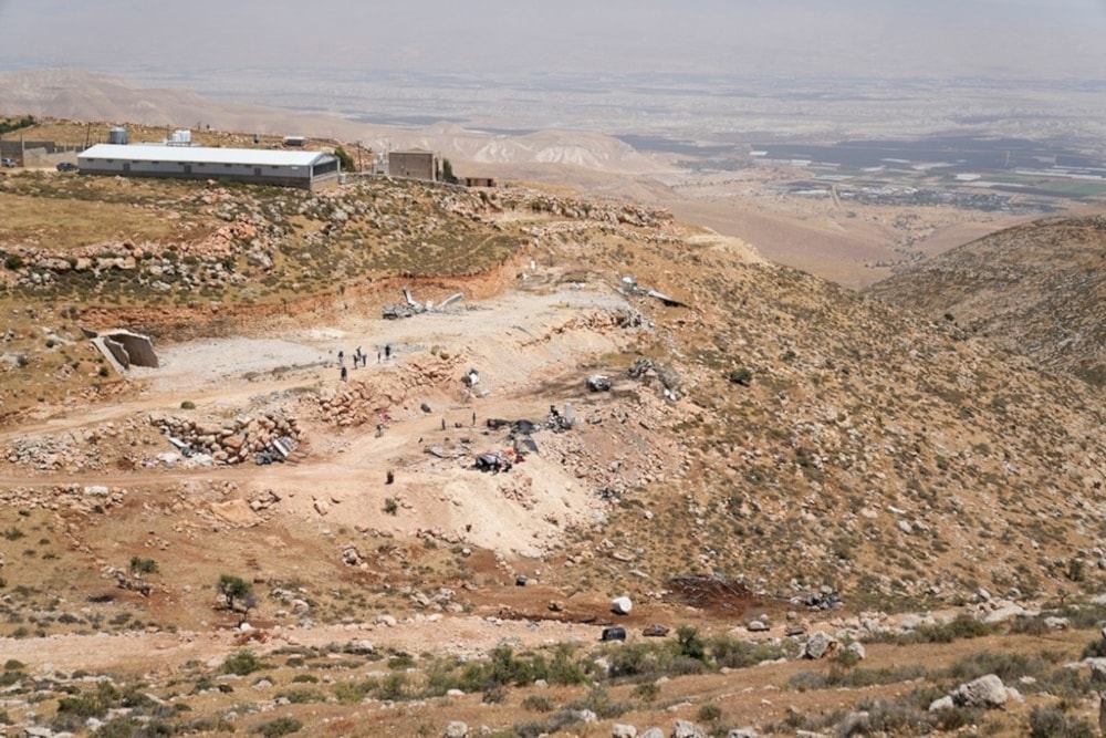 The Israeli settlement Fasayil  Efraim is seen in the background of the site of the demolished tents and shacks of Palestinian bedounis on the outskirts of the West Bank town of Duma on Thursday, May 9,2024. (AP)