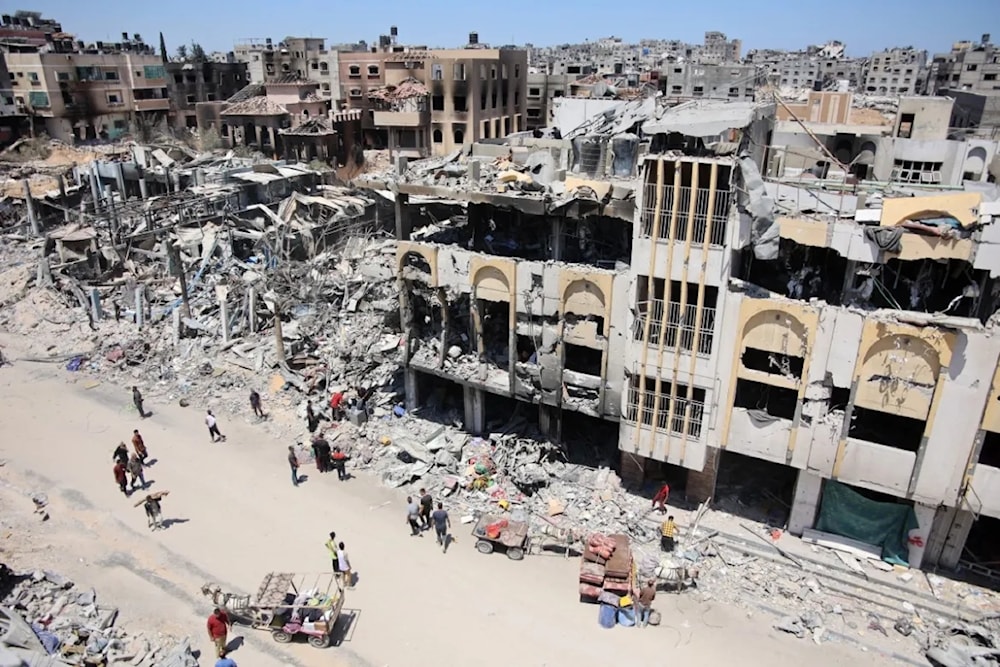 Palestinians carry salvaged belongings as they leave the Jabalia refugee camp on June 3, 2024. (AFP)